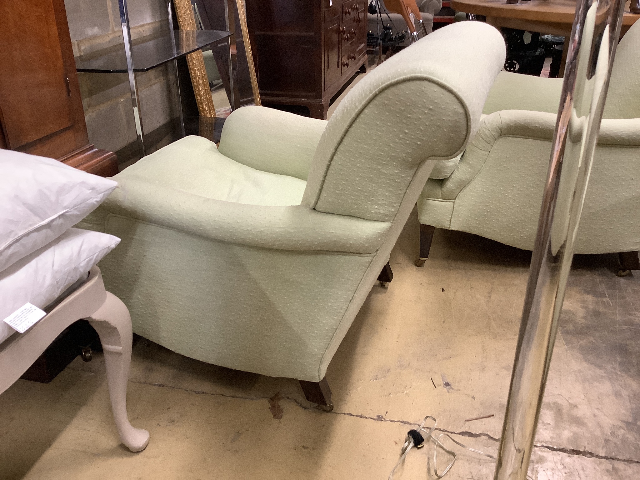 A pair of Howard style armchairs upholstered in lime green fabric. W-70, D-94, H-80cm.